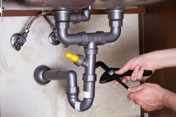 plumber at work to fix a sink