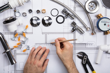 An Architect Drawing Plan On Blueprint