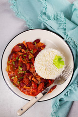 Red Beans with Sausages, Pancetta, Celery Stalks and Rice. View from above, top studio shot