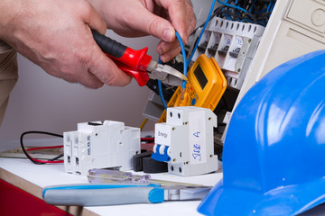 electrician fixing  electrical devices with different tools