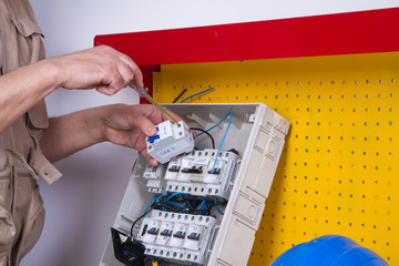 electrician fixing  electrical devices with different tools