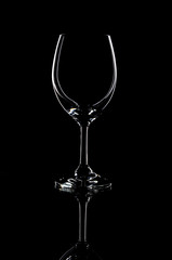 Empty transparent wine glass on black background, isolated