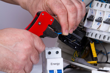 electrician fixing  electrical devices with different tools