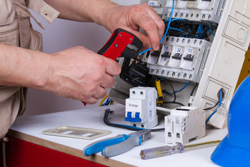 electrician fixing  electrical devices with different tools