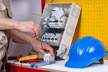 electrician fixing  electrical devices with different tools