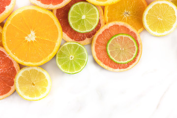 Fototapeta na wymiar Grapefruit, lime, lemon, and orange slices with copyspace