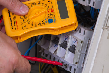 electrician fixing  electrical devices with different tools