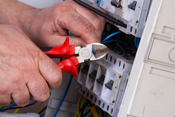 electrician fixing  electrical devices with different tools