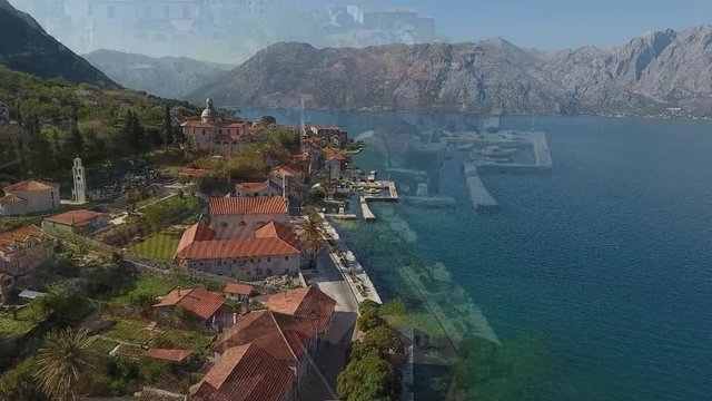 Aerial view of the Prcanj city embankment with ancient houses and church. 
Adriatic sea, Kotor bay, Montenegro.