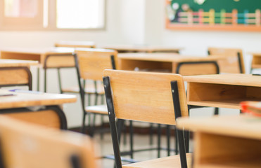 Chair in empty classroom, lecture armchairs in school, or college