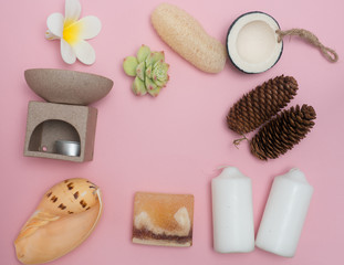 Obraz na płótnie Canvas Aromatherapy product Spa set ,candle ,soap,coconut,flower,shell, massage with pink color background .