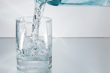 Decanter filling in glass of water splash