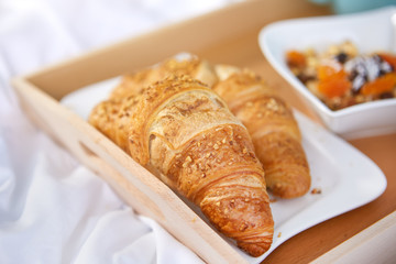 breakfast in bed with coffee and croissants