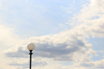 Lonely lamppost against the sky and clouds