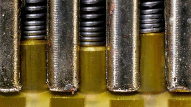 Padlock mechanism block. Shows internal lock springs and key turn. Extreme close up.