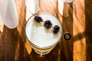 Pisco Sour Cocktail with cherry (natural light)