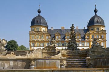 Memmelsdorf, Germany - historic fountain on the background of the palace.