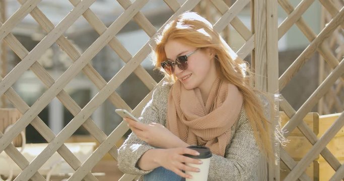 beautiful gitl texting on smartphone in the city