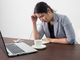 Young frustrated woman working at office desk in front of laptop suffering from chronic daily headaches, treatment online, appointing to a medical consultation, , sick .