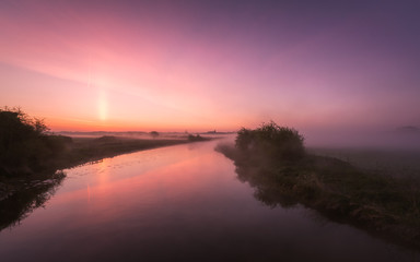 Mist hanging over river Nene in Northamptonshire at sunrise