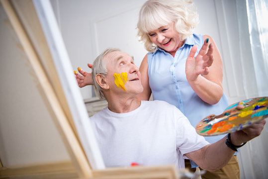 Portrait Of Happy Senior Man And Woman In Art Workshop