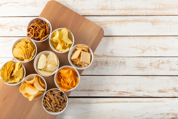 Pretzels in bowls on wooden table from above