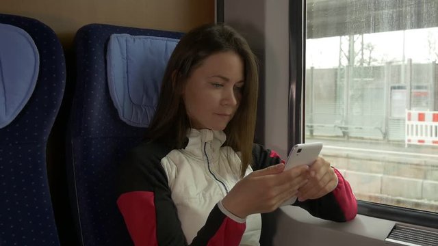 Departing train and the woman with the phone