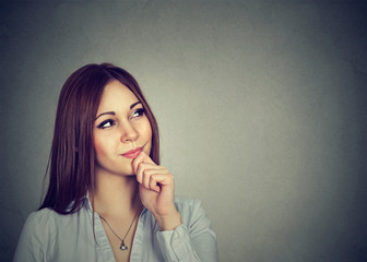 Studio shot of a beautiful young woman looking thoughtful
