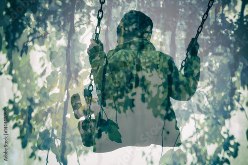 Multiple Exposure Of Kid On Swing And Gorgeous Green Leaves