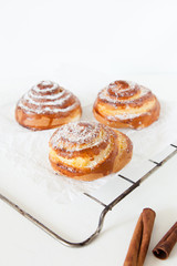 Sweet rolls with sugar and cinnamon on white background.