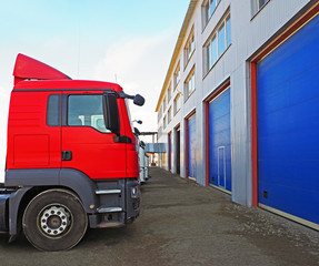 Fototapeta premium Storage and freight terminal. Industrial background. Terminal for truck loading with closed gates. Logistics.