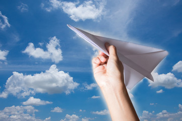 Woman hand holding paper plane,