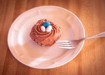Cupcake bird's nest chocolate frosting holiday dessert, plate and fork