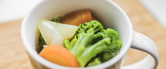 Fresh vegetables: carrots, broccoli, potatoes, onions in a cup. Panoramic shot.