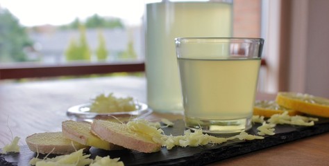 Ginger tea with slices of ginger and lemon and grated ginger root
