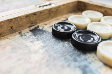 Board game checkers on a shabby board