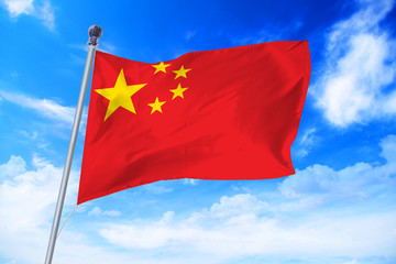 Naklejka na ściany i meble Flag of China developing against a clear blue sky