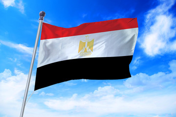 Flag of Egypt developing against a clear blue sky