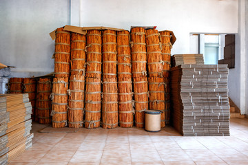 many sheaves, bundles tied long sticks of cinnamon collected for shipping in the factory