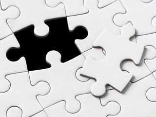 Obraz premium A missing piece of puzzle in a black background