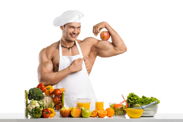 Man bodybuilder cook with apple on biceps