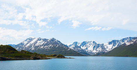 Fototapeta na wymiar Beautiful snowy mountains by the sea. Norway
