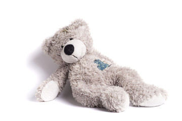 teddy bear with a patch on a white background