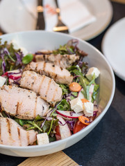 Roasted pork with mixed salad and cheese