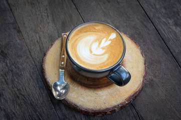 Latte art coffee on table.