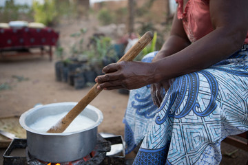 Preparing Nsima in a village in Malawi, Africa - obrazy, fototapety, plakaty