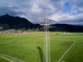 Obraz premium Power line on green meadow