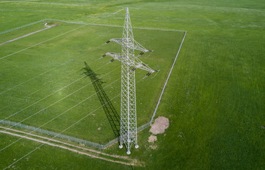 Fototapeta na wymiar Power line on green meadow