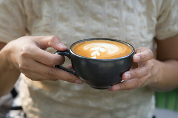 Woman drinking hot latte coffee.