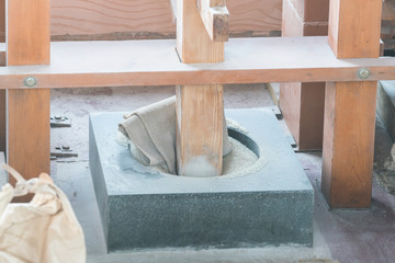 Boiled rice is grinding manually by pestle to make rice cake